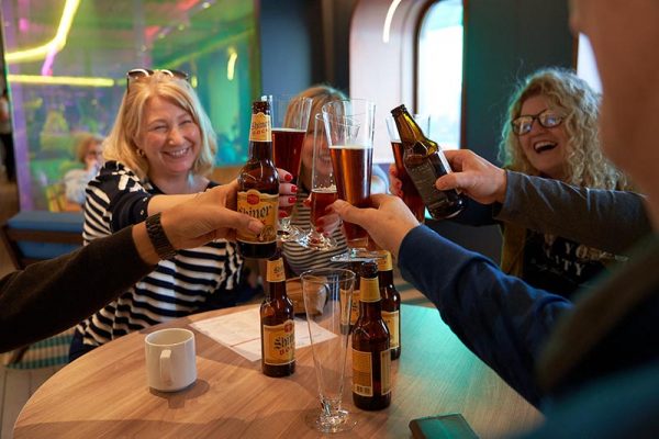 Group cheersing with beers at Draught House